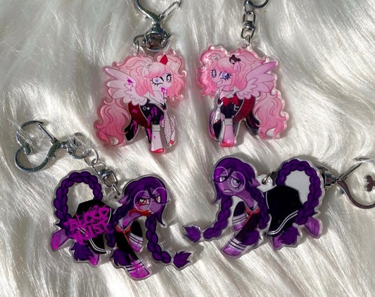 Four acrylic keychains featuring anime-style pony characters, displayed on a white faux fur background. The set includes two pink-haired keychains and two purple-haired keychains, each with a silver metal keyring and clasp.